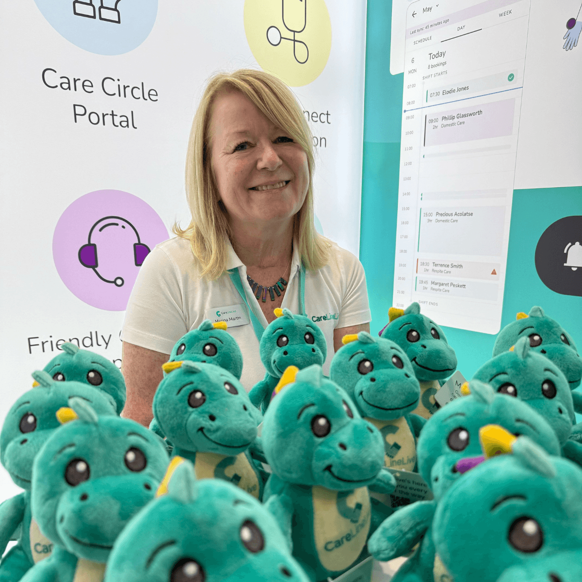 Merina surrounded by Clive the digital dinosaur plushies
